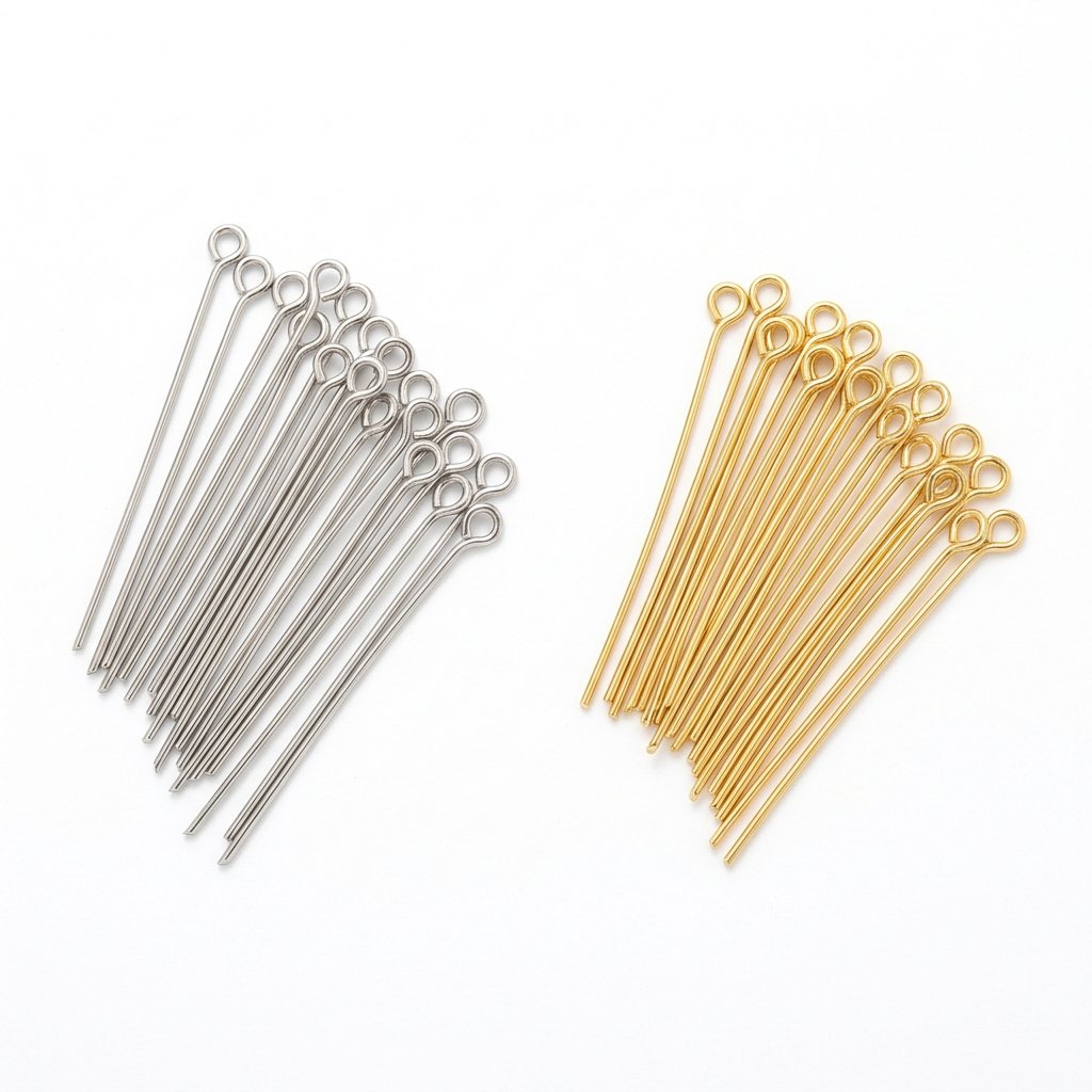 Silver and gold eye pins on a white background